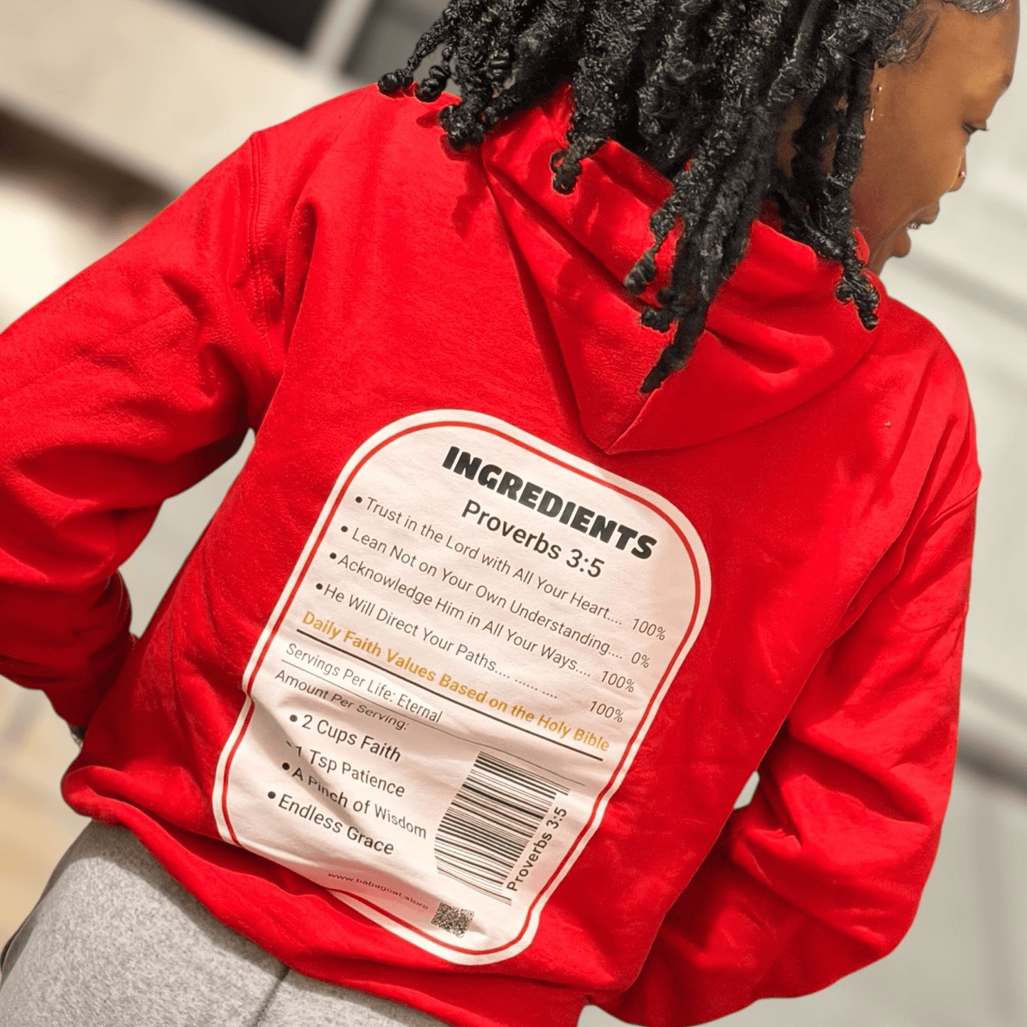 Back view of red hoodie with Proverbs 3:5 scripture and barcode design